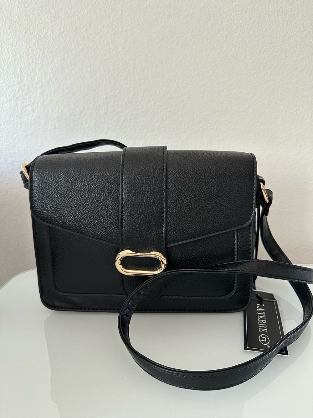 La Terre Crossbody or shoulder bag, black, 
with Gold Accent, new with tag.